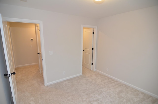 unfurnished bedroom with light colored carpet