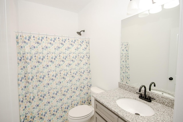 bathroom with vanity, toilet, and curtained shower