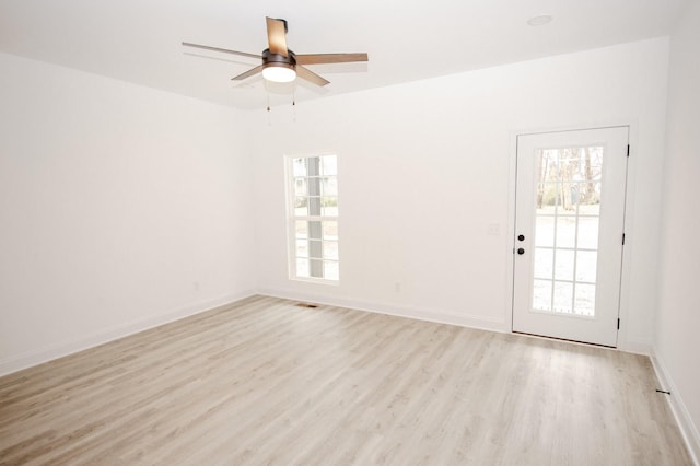 empty room featuring ceiling fan and light hardwood / wood-style floors