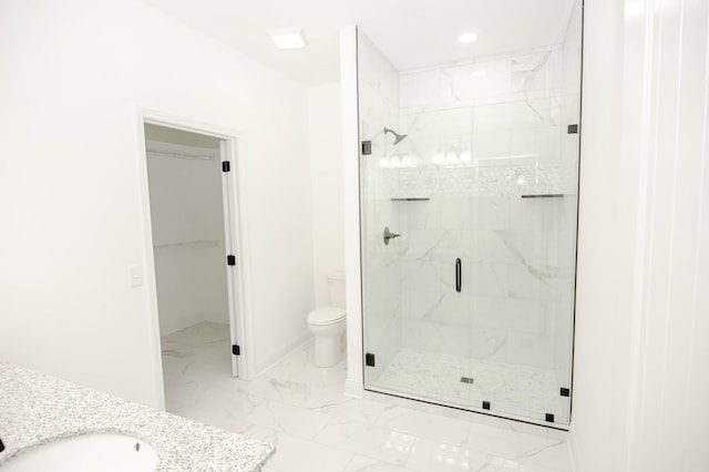 bathroom with a shower with shower door, sink, and toilet