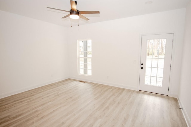 empty room featuring ceiling fan and light wood-type flooring