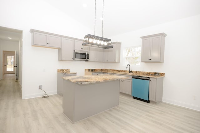 kitchen with dishwashing machine, pendant lighting, light hardwood / wood-style flooring, a center island, and light stone countertops