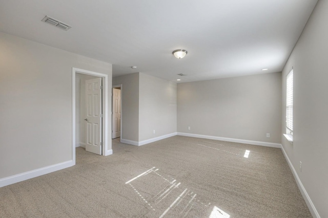 spare room with light colored carpet