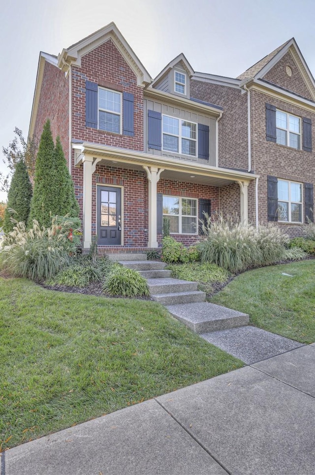 view of front of home with a porch and a front lawn