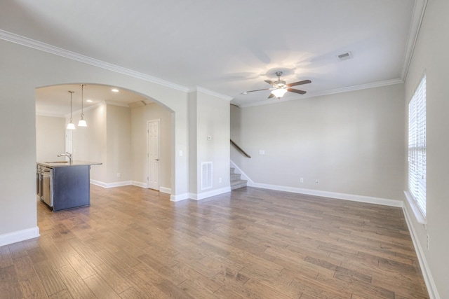 unfurnished room with crown molding, a wealth of natural light, and dark wood-type flooring