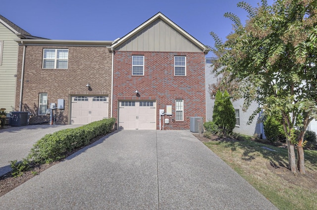 view of front of property featuring central AC unit and a garage