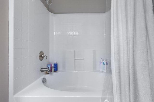 bathroom with shower / tub combo with curtain