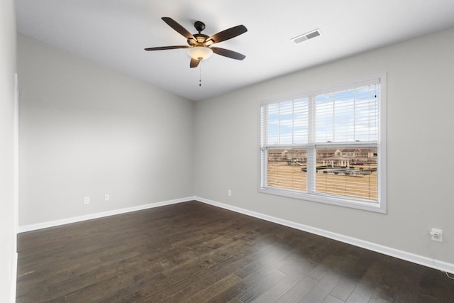 spare room featuring ceiling fan and dark hardwood / wood-style flooring