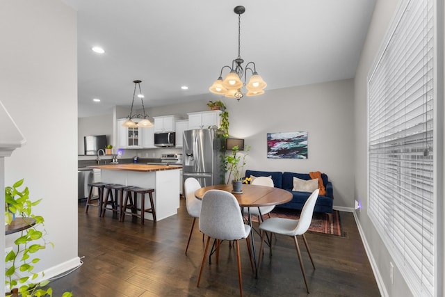 dining area featuring an inviting chandelier and dark hardwood / wood-style floors