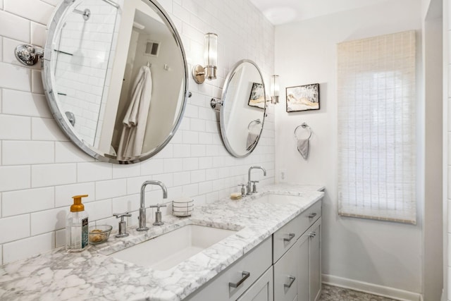 bathroom featuring tasteful backsplash and vanity