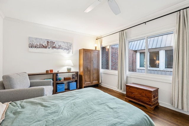 bedroom with crown molding, dark wood-type flooring, and ceiling fan