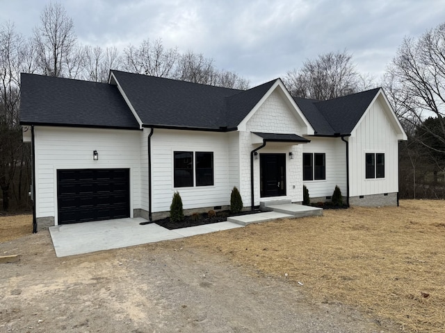 modern inspired farmhouse with a garage