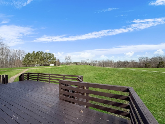 wooden terrace featuring a rural view and a yard