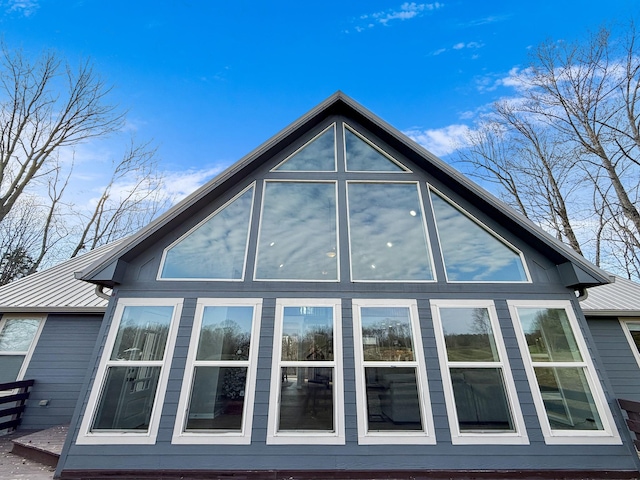 view of side of home with metal roof