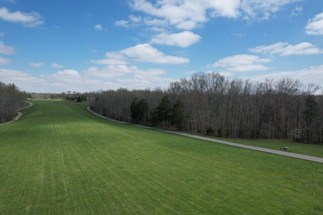 view of home's community featuring golf course view and a lawn