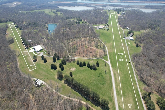 bird's eye view with a rural view, a water view, and a view of trees