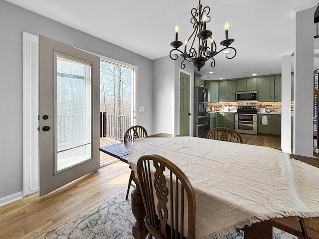 dining space featuring light wood-style floors, recessed lighting, and baseboards