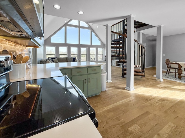 kitchen featuring ornate columns, light countertops, green cabinetry, and light wood finished floors