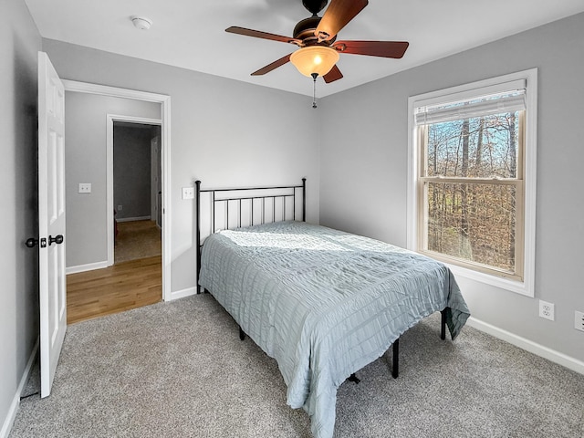 carpeted bedroom featuring ceiling fan and baseboards