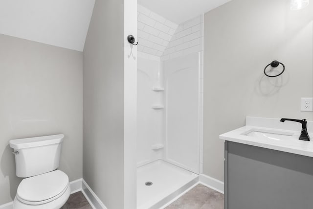 bathroom featuring vanity, a shower, and toilet