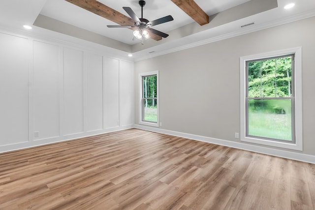 unfurnished room featuring crown molding, light hardwood / wood-style flooring, ceiling fan, beam ceiling, and a tray ceiling