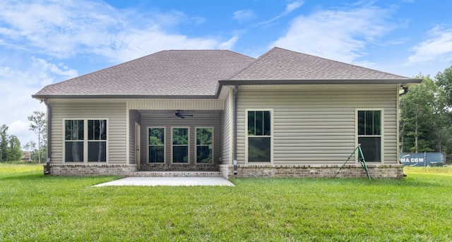 back of property featuring ceiling fan, a patio area, and a lawn