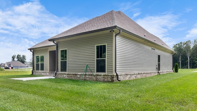 back of house with a lawn and a patio