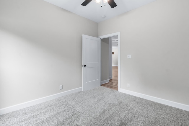 spare room with ceiling fan and carpet