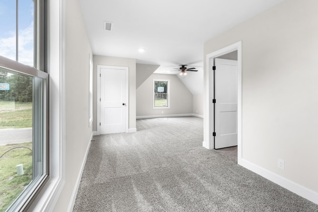 bonus room featuring lofted ceiling, light colored carpet, and ceiling fan