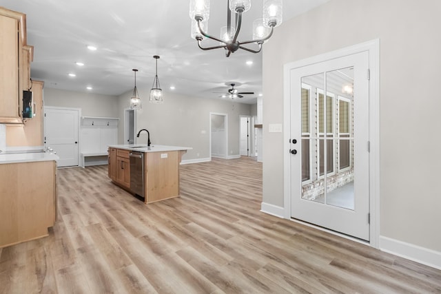 kitchen featuring pendant lighting, light hardwood / wood-style flooring, a kitchen island with sink, ceiling fan with notable chandelier, and stainless steel dishwasher