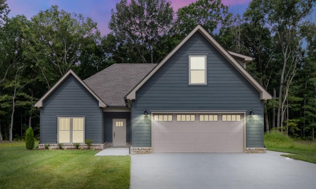 view of front facade featuring a garage and a lawn