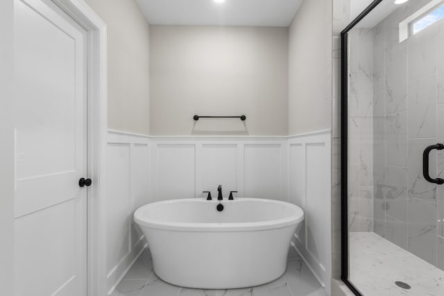 bathroom featuring shower with separate bathtub