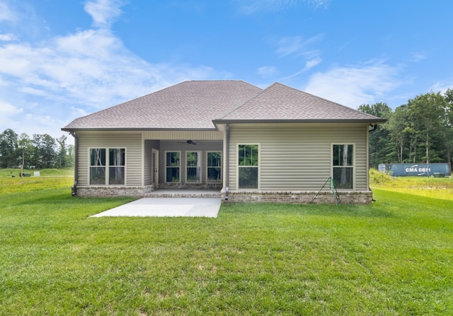 rear view of property featuring a lawn and a patio