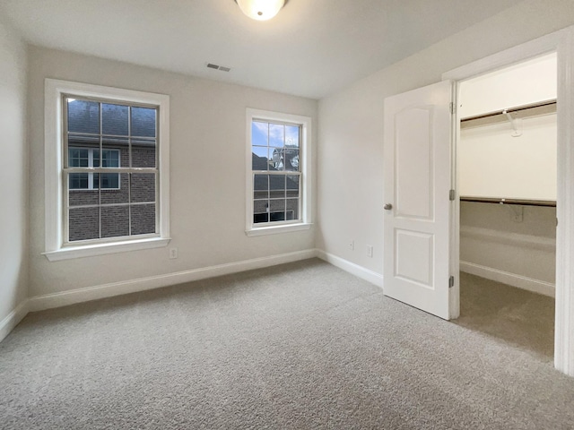 3047 Dogwood Trl, Spring Hill, TN 37174 - unfurnished bedroom featuring carpet flooring, a spacious closet, baseboards, and a closet