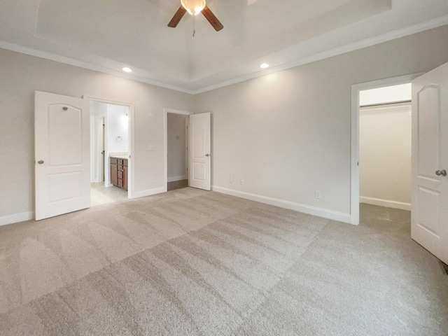3047 Dogwood Trl, Spring Hill, TN 37174 - unfurnished bedroom featuring crown molding, a tray ceiling, light colored carpet, a spacious closet, and recessed lighting