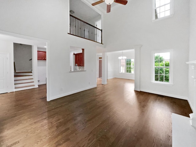 3047 Dogwood Trl, Spring Hill, TN 37174 - unfurnished living room with a high ceiling, ceiling fan, stairs, wood finished floors, and baseboards