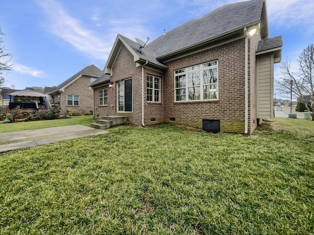 3047 Dogwood Trl, Spring Hill, TN 37174 - back of house featuring brick siding, a lawn, roof with shingles, and crawl space