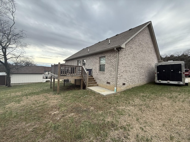 rear view of house featuring a yard and a deck