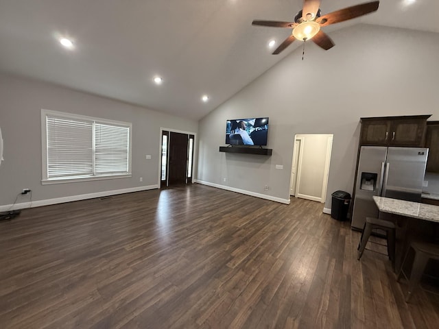 living room with ceiling fan, dark hardwood / wood-style floors, and high vaulted ceiling