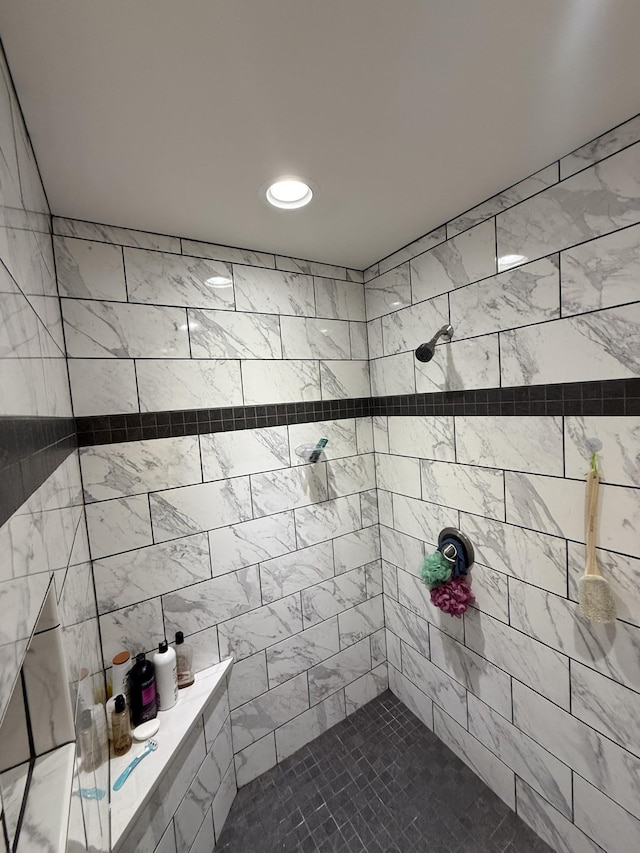 bathroom with a tile shower