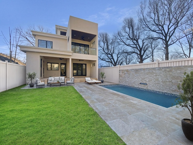 back of house featuring a fenced in pool, ceiling fan, an outdoor living space, a patio area, and a balcony