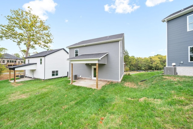 back of house featuring a yard, a patio area, and central air condition unit