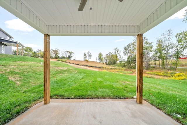 view of yard with ceiling fan and a patio area