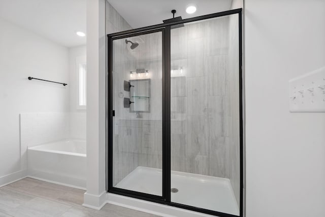 bathroom with shower with separate bathtub