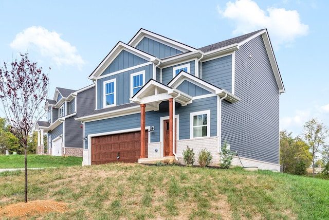 craftsman-style house with a garage and a front lawn