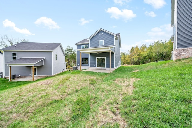 rear view of property featuring a yard and a patio area