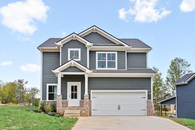 craftsman-style home featuring a garage and a front lawn