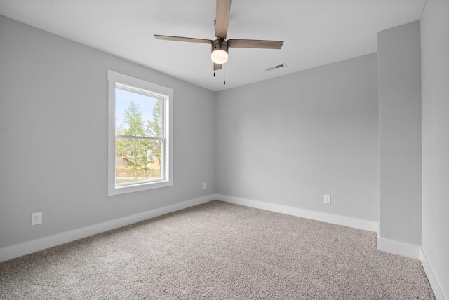 spare room featuring ceiling fan and carpet