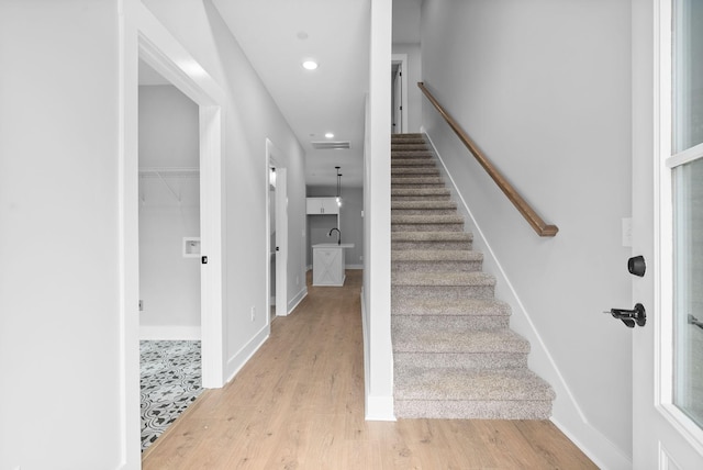 stairway featuring hardwood / wood-style floors