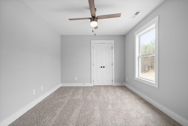 carpeted empty room with ceiling fan